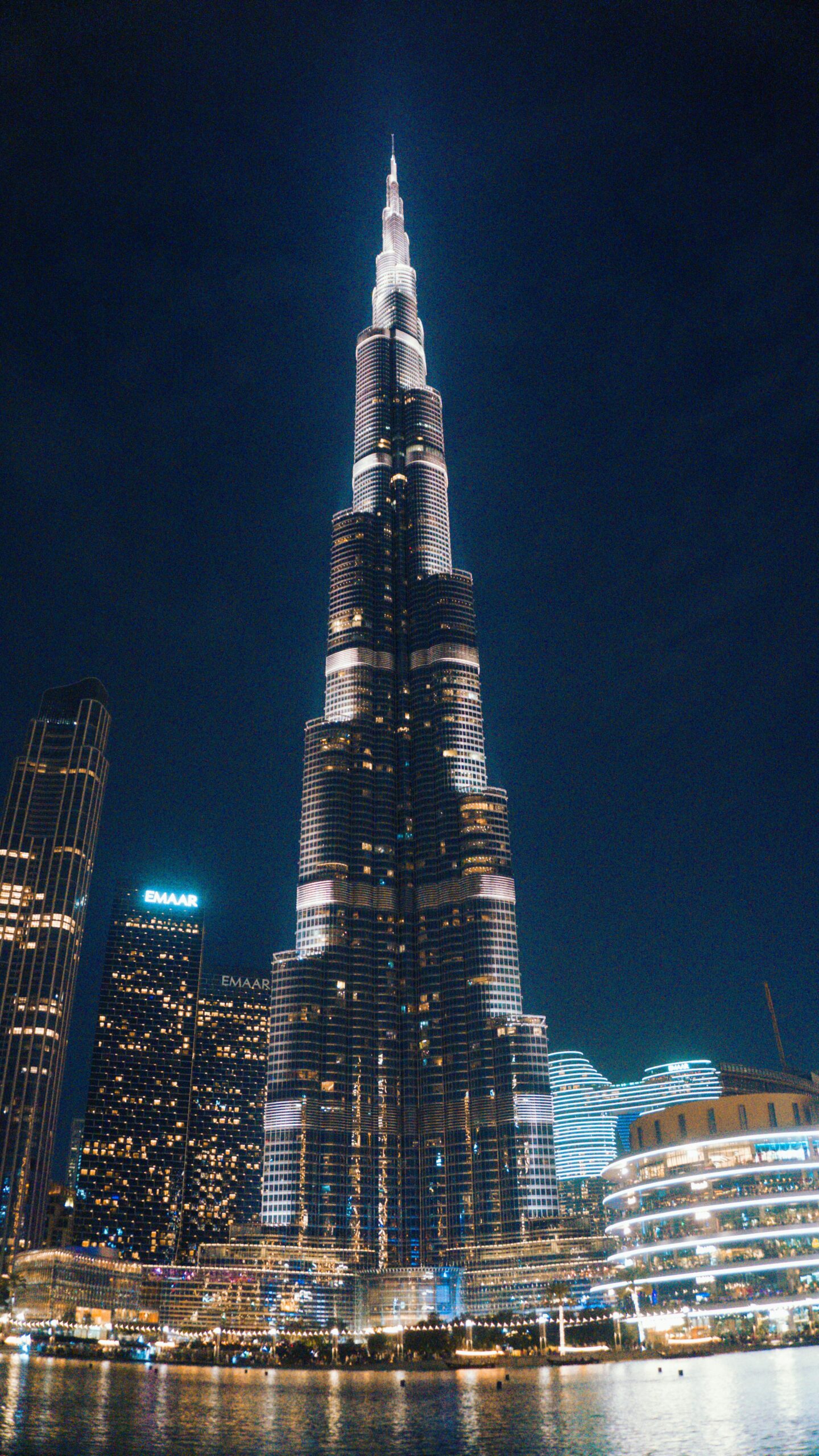 Stunning nighttime view of the illuminated Burj Khalifa in downtown Dubai.