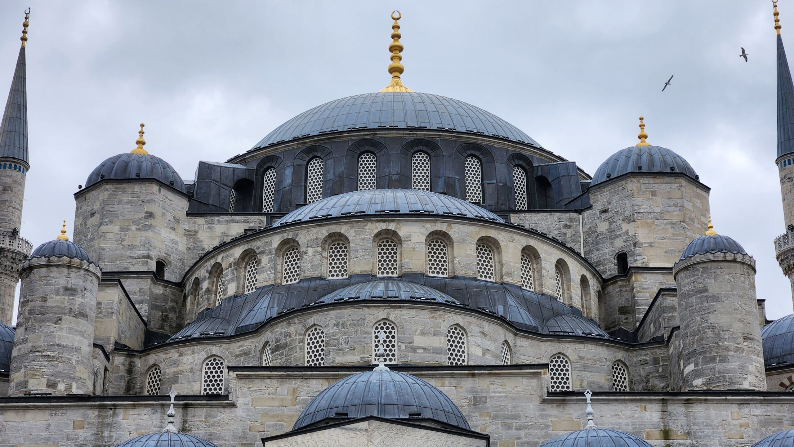 Close-up of the domes of Sultan Ahmed Mosque showcasing Ottoman architecture in Istanbul, Türkiye.