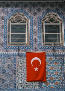 Decorative tiled facade with Turkish flag and ornate windows.