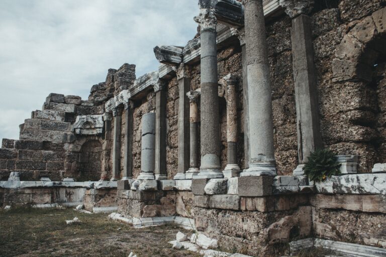 Explore the majestic ancient Roman ruins featuring impressive stone columns and intricate carvings.